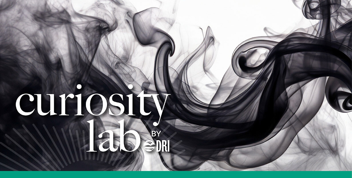 Curiosity Lab by DRI sunburst logo over an image of swirling black smoke on a white background.
