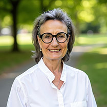 Batjer, Marybel UPDATED 2025 Headshot of Marybel Batjer outside in front of a green park with trees wearing glasses and white shirt.