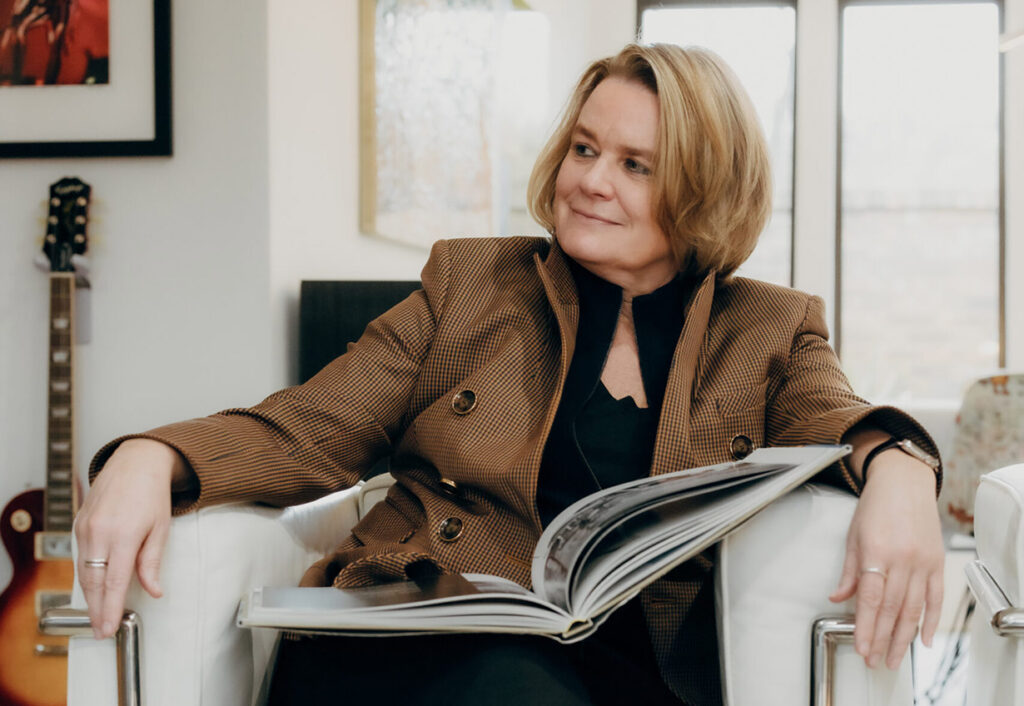Image of Beth Campbell sitting in a chair with a book in her lap.