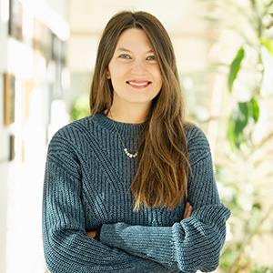 Cara Schaefer 300px Headshot of Cara smiling with arms folded wearing a teal sweater.