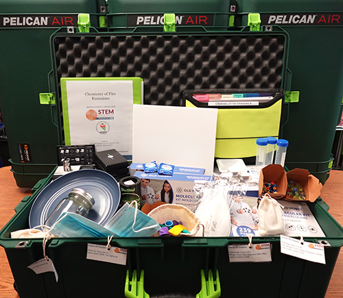 An open Green Box displaying STEM materials for the Chemistry of Fire Emissions Lesson.