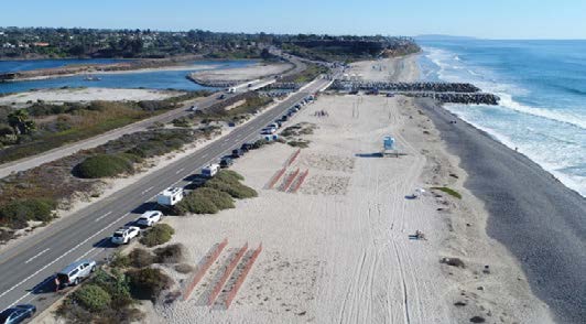 CoastalAdaptationOneSheet3 Ponto Beach Cars are parked along a stretch of beach with the ocean waves to the right and tidal pools to the left.