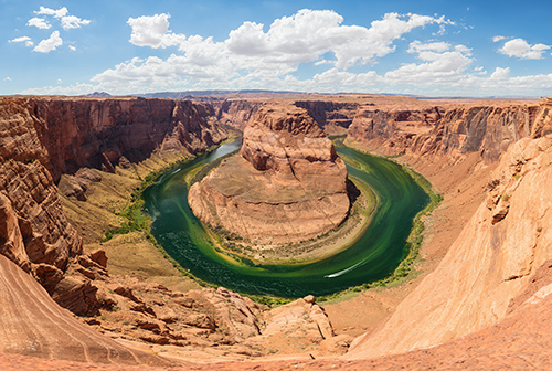 Colorado River Storymap Featured Image The green Colorado River bending around a rock formation in a canyon so that it resembles a horseshoe shape.
