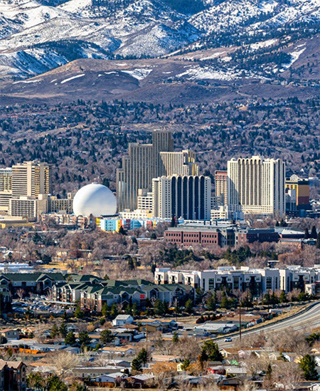 Screenshot Downtown Reno with snowcapped mountains in the distance.