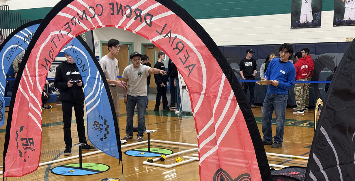Students working out a drone obstacle course. 
