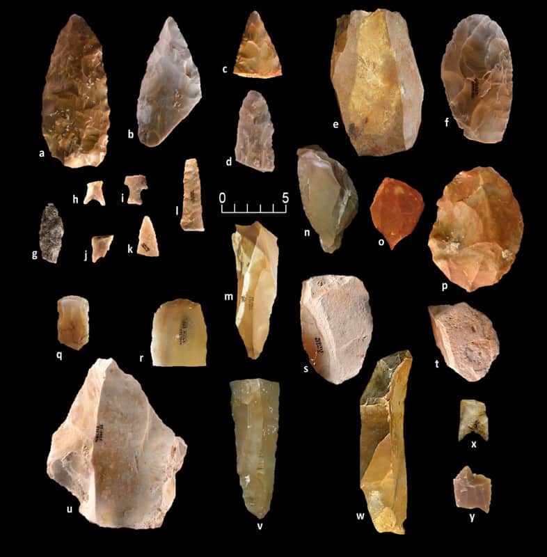 Stone tools on black background.