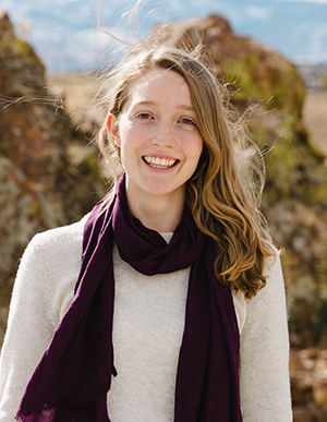 Hahn_headshot 300px headshot of Lily Hahn outside in front of a rocky landscape wearing a scarf and sweater.