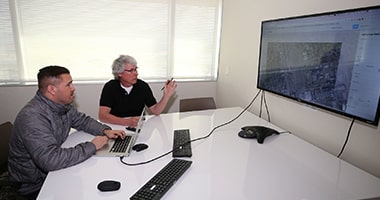 Health-Sciences-Thumbnail researchers look at data on a screen