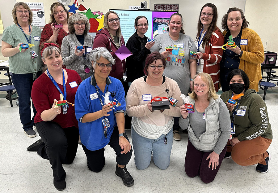 IMG_0248-1-scaled_900px Group photo of educators holding their robot creations after a training session.