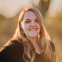 Kathryn's headshot taken outside in the golden glow of sunset.