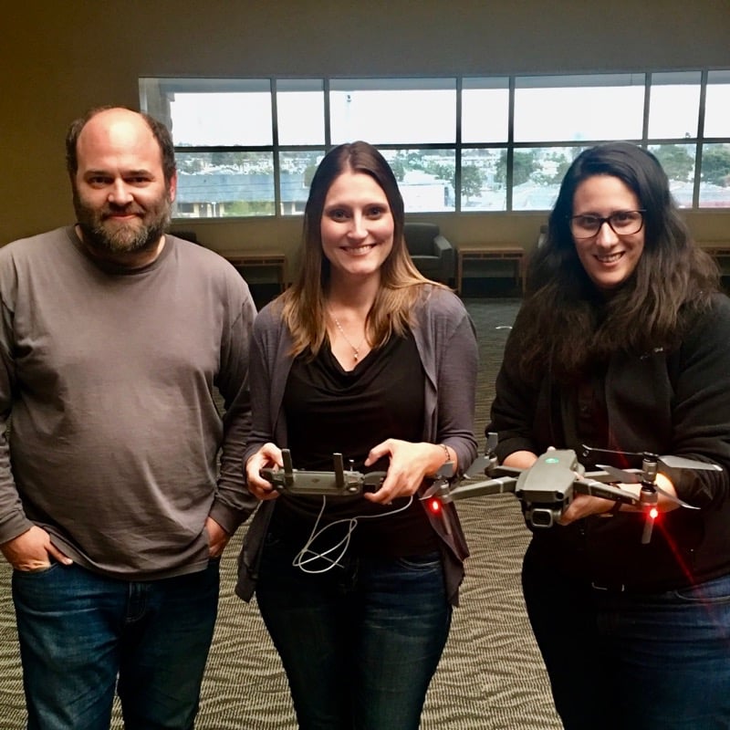 Researchers holding drones.