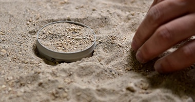 hand sifting through sand