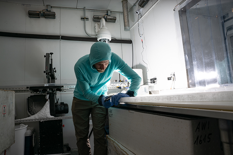 Nathan Chellman in the ice core lab preparing a sample.