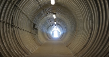 metal tunnel with light at the end