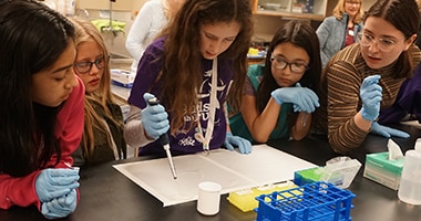 group of young girls doing an experiment