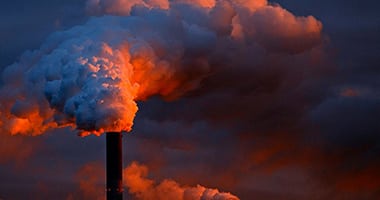 steam coming out of a smoke stack