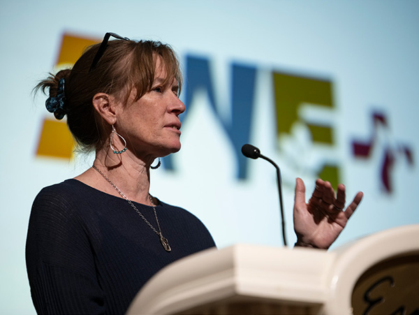 Tamara Wall AWE Tamara Wall at the podium speaking at AWE+ Summit 2024
