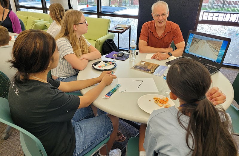 Tim-Minor-and-UNR-students-web Tim Minor and students at UNR sitting at a table