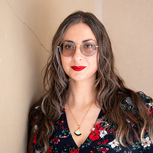 Tsvet Headshot 300px Headshot of Tsvetelina in front of a neutral wall smiling and wearing glasses.
