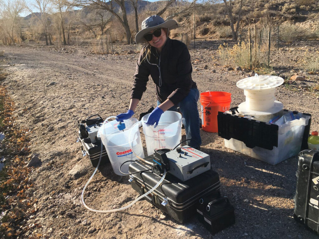 scientist working with water in the field