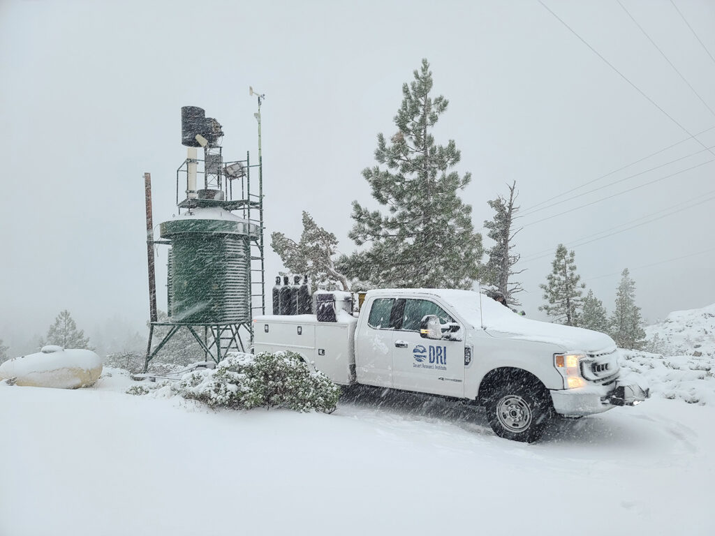 resized_20221101_155917 A DRI cloud-seeding station and truck in a snowy, mountain-top setting.
